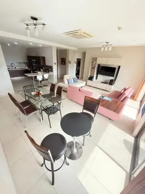 a living room with a couch and a table and chairs at Jaco Bay Unit 8th Floor in Jacó