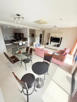 a living room with a couch and a table and chairs at Jaco Bay Unit 8th Floor in Jacó