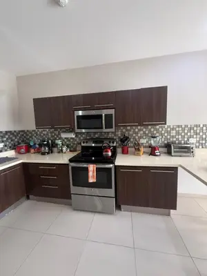 a kitchen with a stove and a microwave at Jaco Bay Unit 8th Floor in Jacó