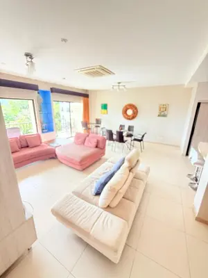a large living room with pink and white furniture at Jaco Bay Unit 8th Floor in Jacó