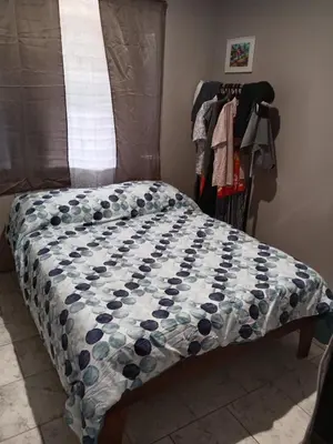 a bed with a quilt on it in a bedroom at Pacific villa lisn in Nicoya