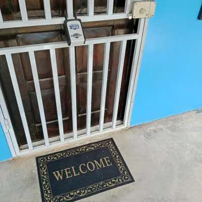 a welcome sign in front of a gate at Pacific villa lisn in Nicoya