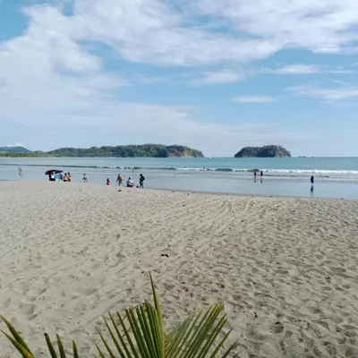 a group of people on a beach with the ocean at Pacific villa lisn in Nicoya