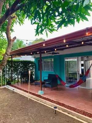 a porch with a hammock in a house at Bejuco House in Parrita