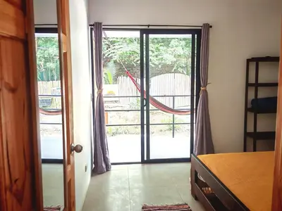 a room with a door open to a patio at Moon Home SOUL #1 in Playa hermosa