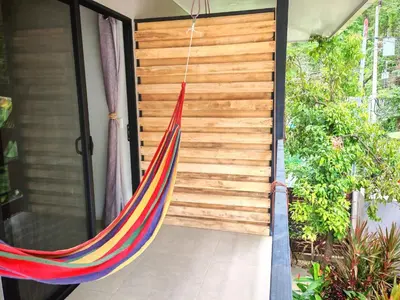 a hammock hanging from a door of a house at Moon Home SOUL #1 in Playa hermosa