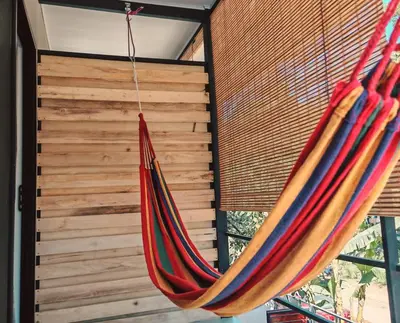 a hammock hanging in a room next to a window at Moon Home SOUL #1 in Playa hermosa