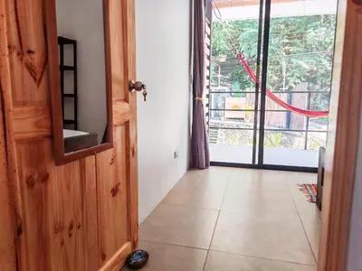 an open door to a room with a view of a porch at Moon Home SOUL #1 in Playa hermosa