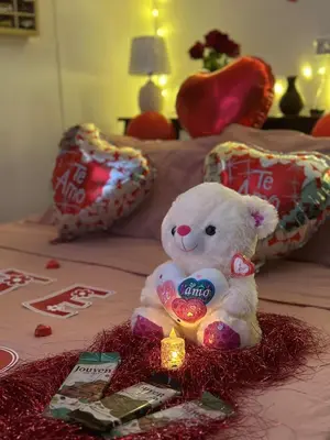 a white teddy bear sitting on top of a bed at Cabaña El Mirador de las Montañas in Turrialba