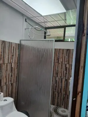 a bathroom with a shower with a toilet and a sink at Casa cerca de playas y rios