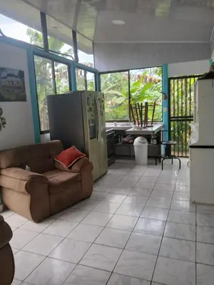 a living room with a couch and a refrigerator at Casa cerca de playas y rios