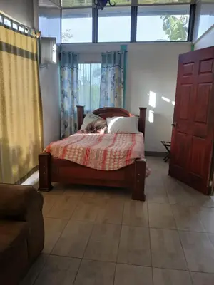 a bedroom with a bed and a window at Casa cerca de playas y rios