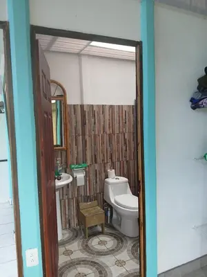 a bathroom with a toilet and a sink at Casa cerca de playas y rios