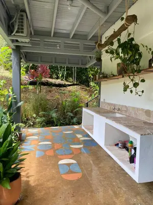 a patio with a colorful tile floor in a yard at Jungle Beach House in Uvita
