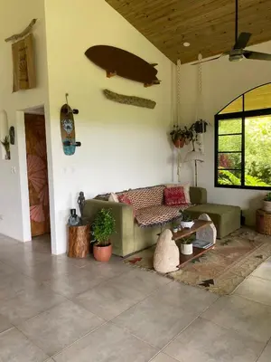 a living room with a couch and a table at Jungle Beach House in Uvita