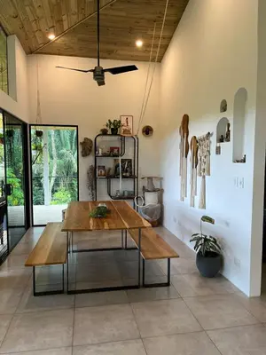 a dining room with a table and a ceiling at Jungle Beach House in Uvita