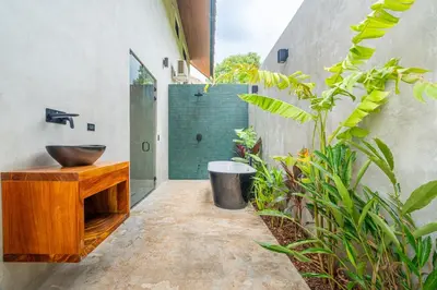 a bathroom with a wooden sink and a shower at Mandala Ojochal Boutique Resort & Retreat Center in Ojochal