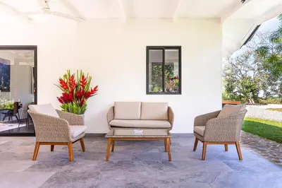 a patio with two chairs and a coffee table at Mandala Ojochal Boutique Resort & Retreat Center in Ojochal