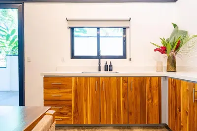 a kitchen with wooden cabinets and a sink at Mandala Ojochal Boutique Resort & Retreat Center in Ojochal