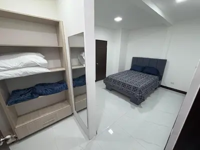 a reflection of a bedroom with a bed and a mirror at Casa Viveo, a modern and spacious house! in San José