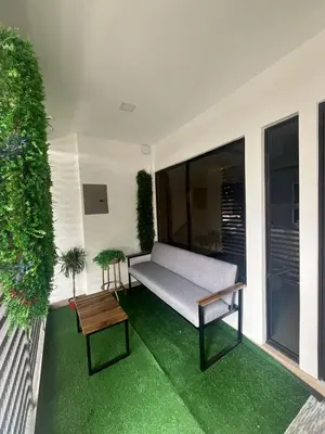 a patio with a bench and a table on avisor at Casa Viveo, a modern and spacious house! in San José