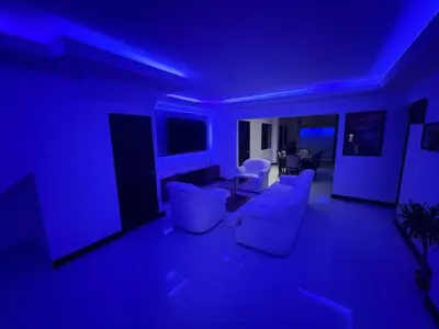 a living room with blue lighting and white furniture at Casa Viveo, a modern and spacious house! in San José