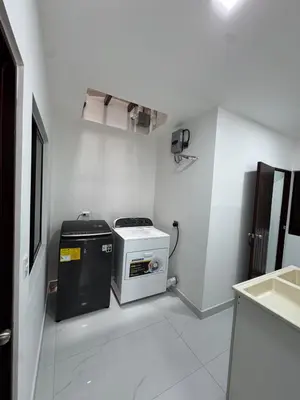 a small white kitchen with a stove and a sink at Casa Viveo, a modern and spacious house! in San José