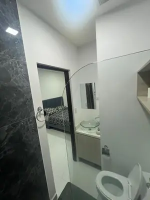 a bathroom with a toilet and a sink at Casa Viveo, a modern and spacious house! in San José