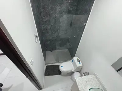 a small bathroom with a toilet and a sink at Casa Viveo, a modern and spacious house! in San José
