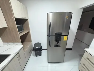 a stainless steel refrigerator sitting in a kitchen at Casa Viveo, a modern and spacious house! in San José