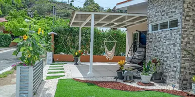 a garden with a pergola on a house at JJ Lux Residential in Jacó
