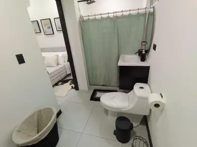 a bathroom with a toilet and a sink and a shower at JJ Lux Residential in Jacó