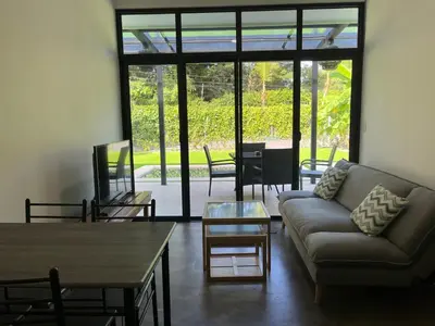 a living room with a couch and a table at Casa Flor in Playa Avellana