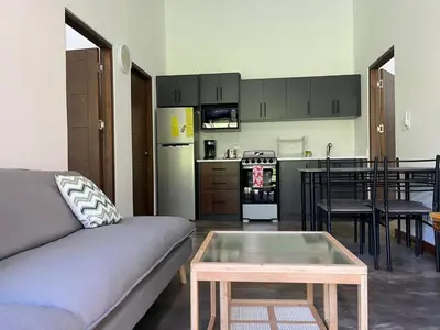 a living room with a couch and a table at Casa Flor in Playa Avellana