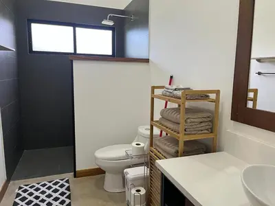 a bathroom with a toilet and a sink at Casa Flor in Playa Avellana