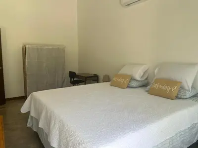 a bedroom with a bed with two pillows on it at Casa Flor in Playa Avellana
