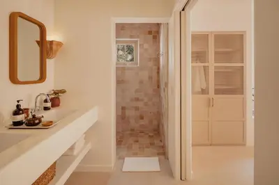 a bathroom with a sink and a shower with a mirror at Hotel Fermata in Santa Teresa Beach