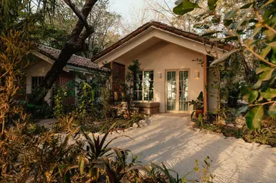 a small house with a pathway leading to the front door at Hotel Fermata in Santa Teresa Beach