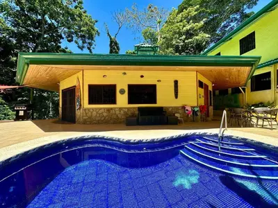 a swimming pool in front of a house at Jungle Creek, Casita Colibri, Studio with Big Patio in Quepos