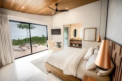 a bedroom with a large bed and a balcony at NEW - Private Villa - Highest Point Manuel Antonio in Manuel Antonio
