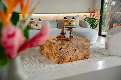a living room with a coffee table with a wooden stumpructangering at NEW - 360 Private Oasis - Ocean & Jungle Views in Manuel Antonio