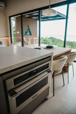 a kitchen with a island with a counter top at NEW - 360 Private Oasis - Ocean & Jungle Views in Manuel Antonio