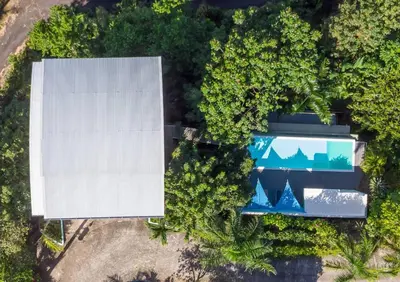 an overhead view of a house and a swimming pool at Tortuga, 1BR Apartment in Villa Mar y Sol, Pool, Big Deck, and Wildlife in Manuel Antonio