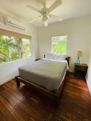 a bedroom with a bed and a ceiling fan at Costa Rica Beach Bungalow in Playa Hermosa