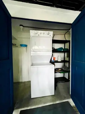 a small white refrigerator in a room with blue doors at Costa Rica Beach Bungalow in Playa Hermosa