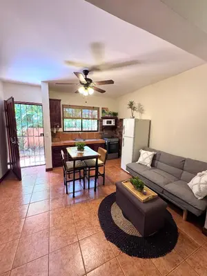 a living room with a couch and a table at Tiny Paradise Ground Floor Studio in Coco
