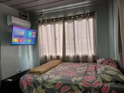 a small bedroom with a bed and a tv at Apartamentos Modular Bahía Ballena in Bahia