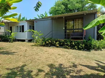 a house with a yard in front of it at Apartamentos Modular Bahía Ballena in Bahia