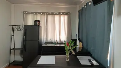 a small kitchen with a table and a refrigerator at Apartamentos Modular Bahía Ballena in Bahia