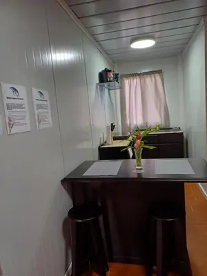 a small room with a counter and two stools at Apartamentos Modular Bahía Ballena in Bahia